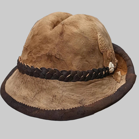 Brown amadou hat with braided band on a white surface